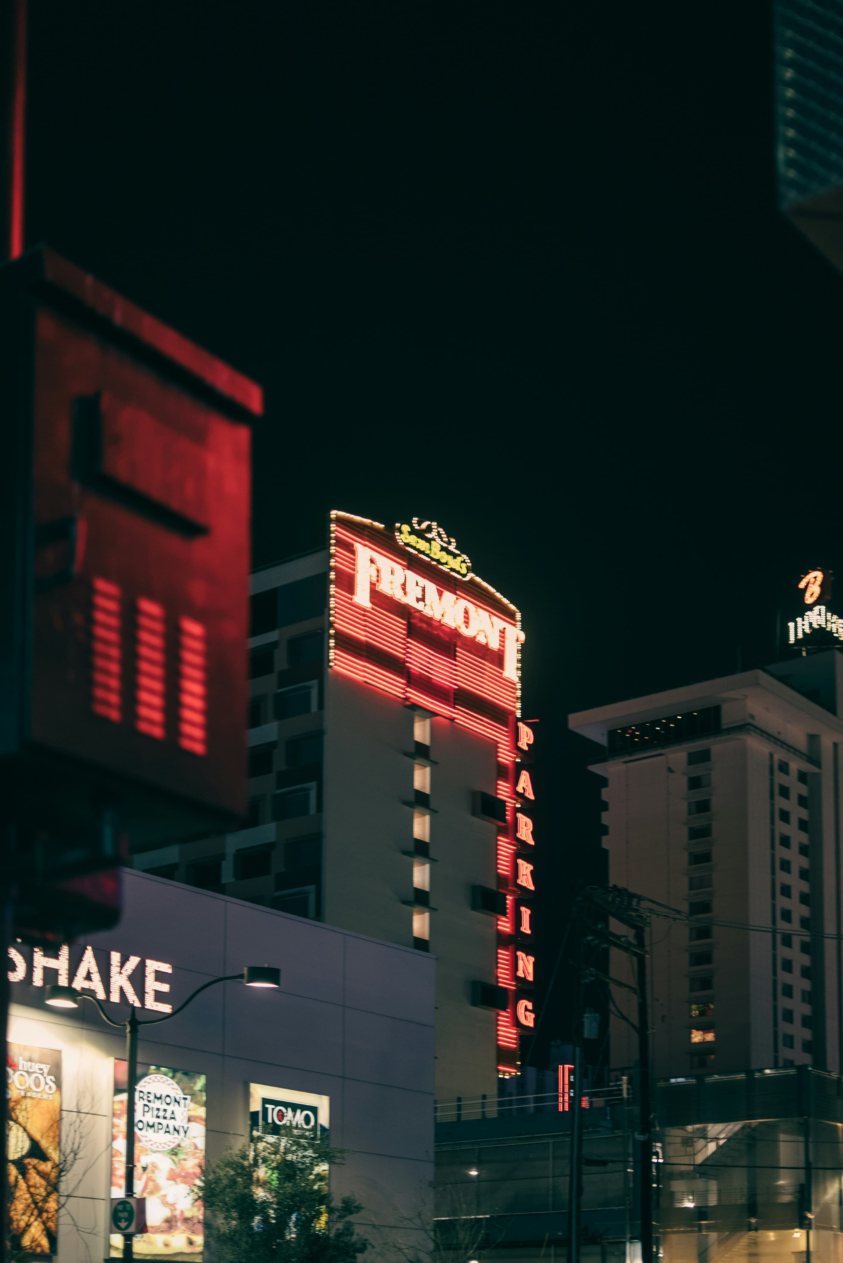 Fremont Street facades and the Fremont Hotel sign lit up after dark